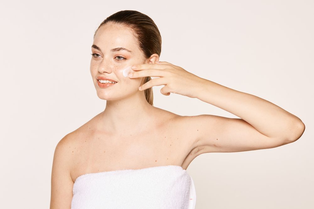 Amiable female taking care of face