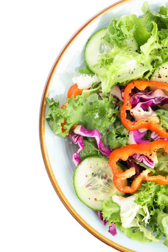 Plate with fresh salad isolated on plain background