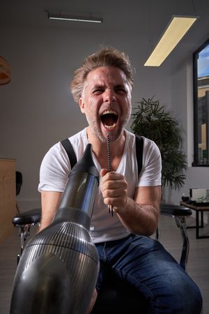 Brutal man singing in hairbrush and drying hair