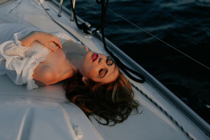 Woman in luxury dress resting on yacht