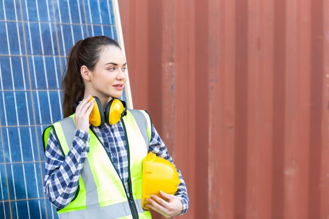 Portrait of female worker or engineer woman in safety uniform and helmet at construction site