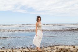 Charming young woman on shore near water