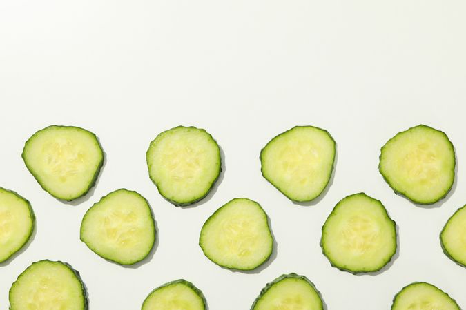 Cucumber slices on blank background, top view