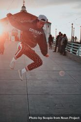 Man in hoodie jumping on street during sunset 4BEXk5