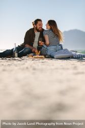 Beautiful couple enjoying picnic day on the beach 48VMR0