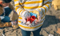 Boy hands with garbage from the beach