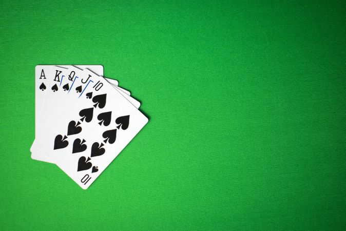 royal flush cards on green background