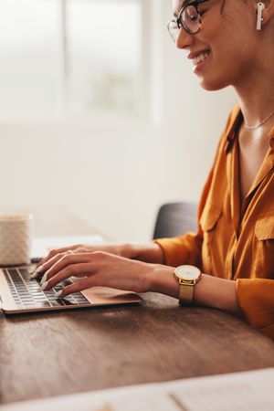 Woman writing a blog on laptop
