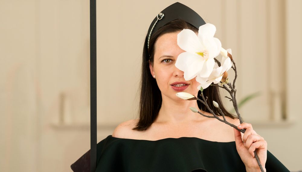 Woman posing with a white flower