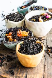 Loose leaf tea varieties on wooden board