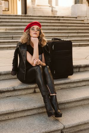 Cheerful tourist drinking on steps