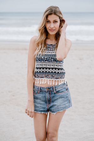 Happy female laughing on sandy beach