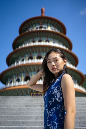Woman in dress standing next to Wuji Tianyuan Temple