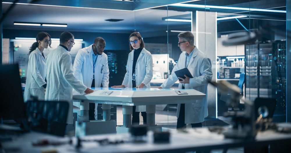 Engineer, Scientists and Developers Gathered Around Illuminated Conference Table in Technology Research Center