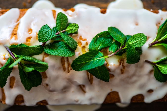 Close up of top of homemade lemon cake with fresh mint garnish