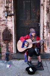 Woman in purple wig playing guitar, Louisiana