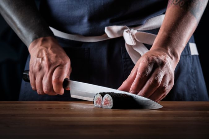Male shushi man hands preparing different pieces of makis