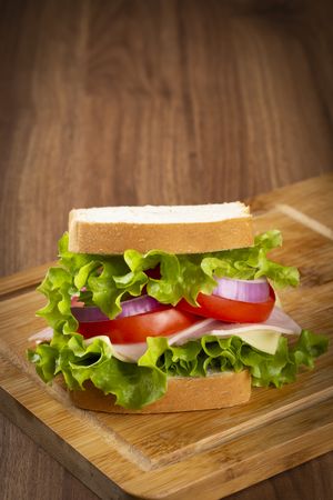 Natural sandwich. Sandwich with cheese, ham, lettuce, tomato and red onion.