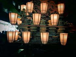 Lit lanterns at night in close-up