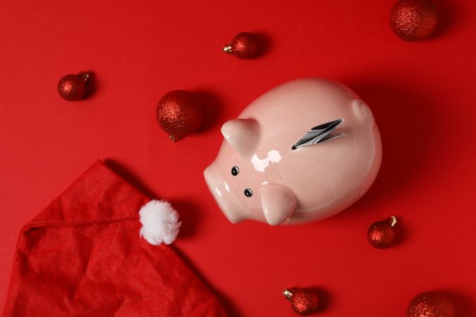 Concept of Christmas finance with piggy bank, top view