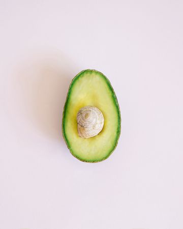 Flat lay of cut avocado on paper background