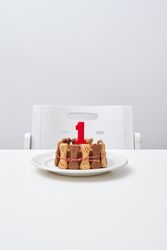 Delicious cake with candle on table
