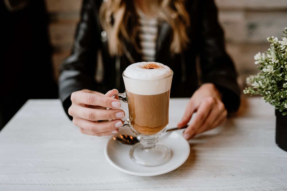 Woman drinking coffee from a glass