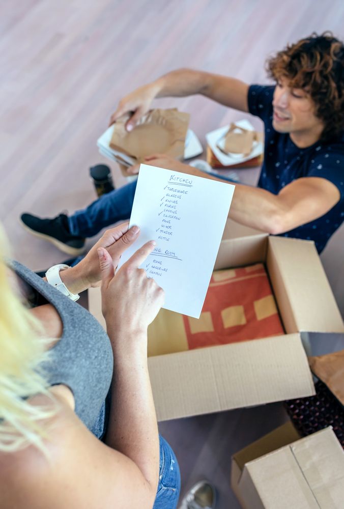 Couple unpacking moving boxes
