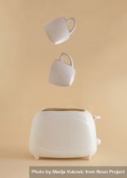 Coffee mugs suspended above a toaster 0yAGR0