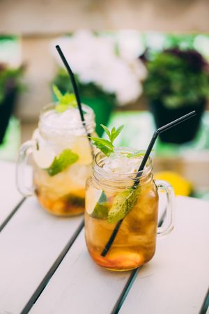 Mojitos in mason jar on wooden table