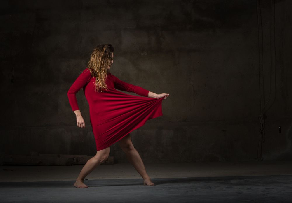 Young woman dancing in darkness