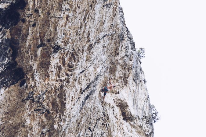 Anonymous man climbing rock