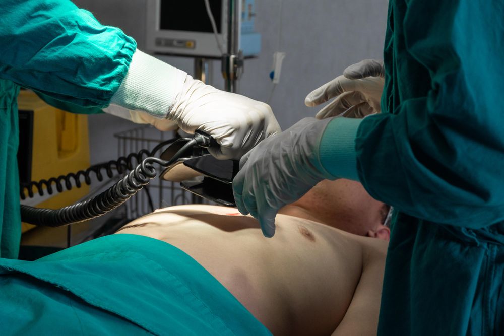 Two doctors treating patient in emergency room