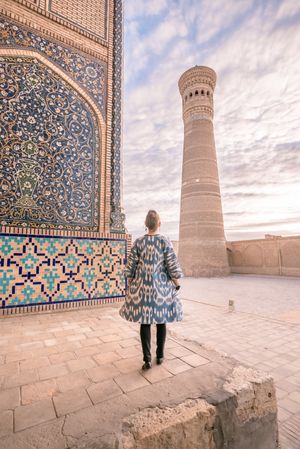 Unrecognizable female standing on old square
