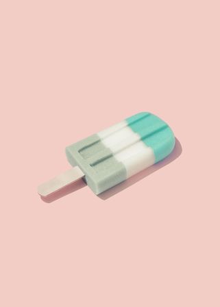 Colorful ice cream popsicle on pastel pink background