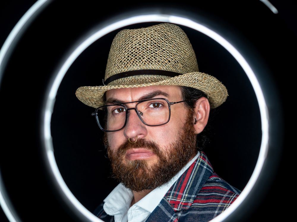 Stylish man in elegant suit behind special circle light