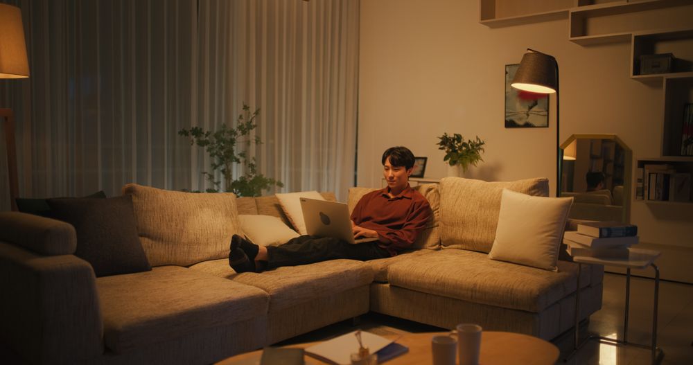 South Korean Man Resting on a Sofa at Home