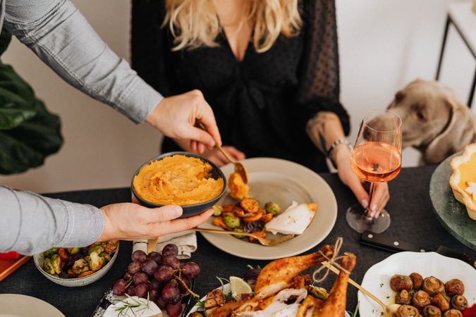 Cropped image of two people eating Thanksgiving dinner