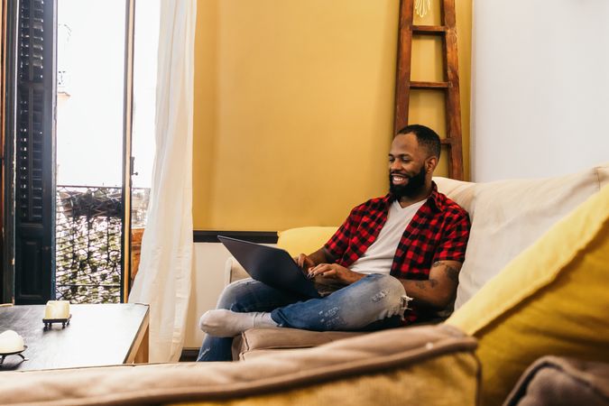 Black man using laptop at home