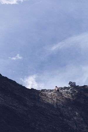 Anonymous man climbing rock