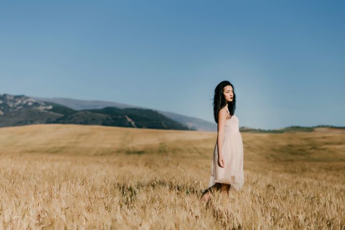 Model standing in field with copy space