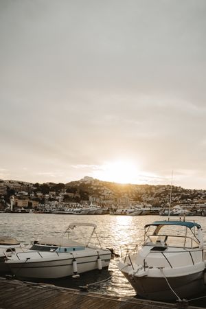 Yachts docked in sea port at sunset