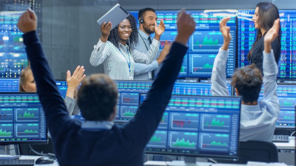 Multi-Ethnic Team of Traders Have Successful Day at the Stock Exchange Office.
