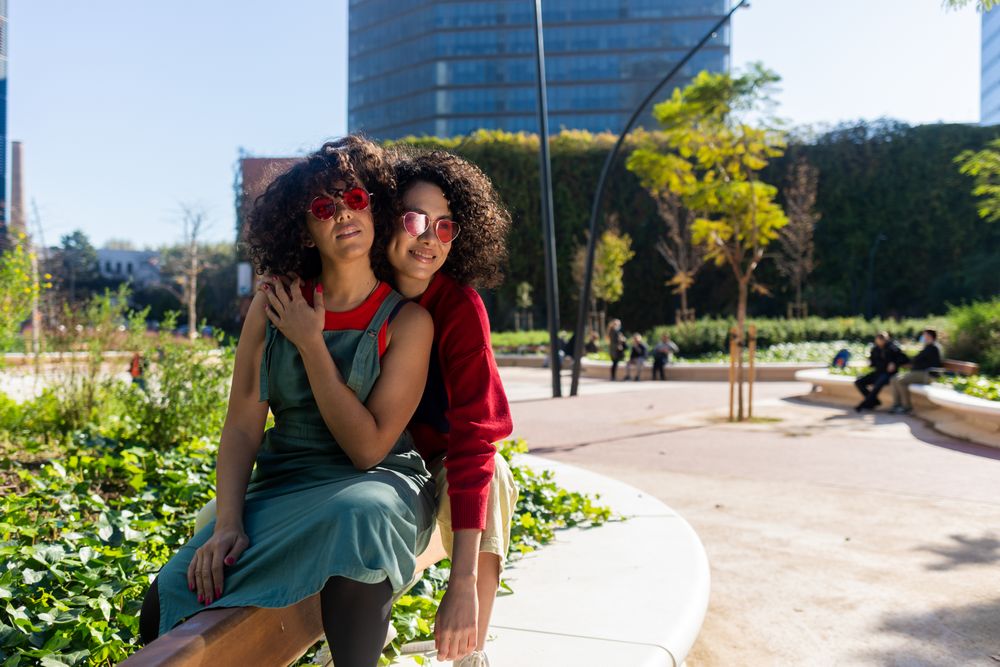 Two female friends having fun in city park together