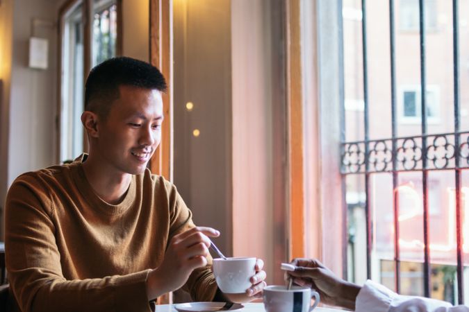 Asian man on a date in a coffee shop