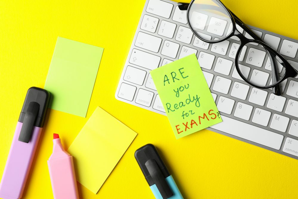 Paper note of “are you ready for exams” on computer keyboard with stationary