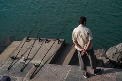 Man  waiting with three fishing lines in the water