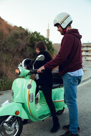Man helping woman sit to bike