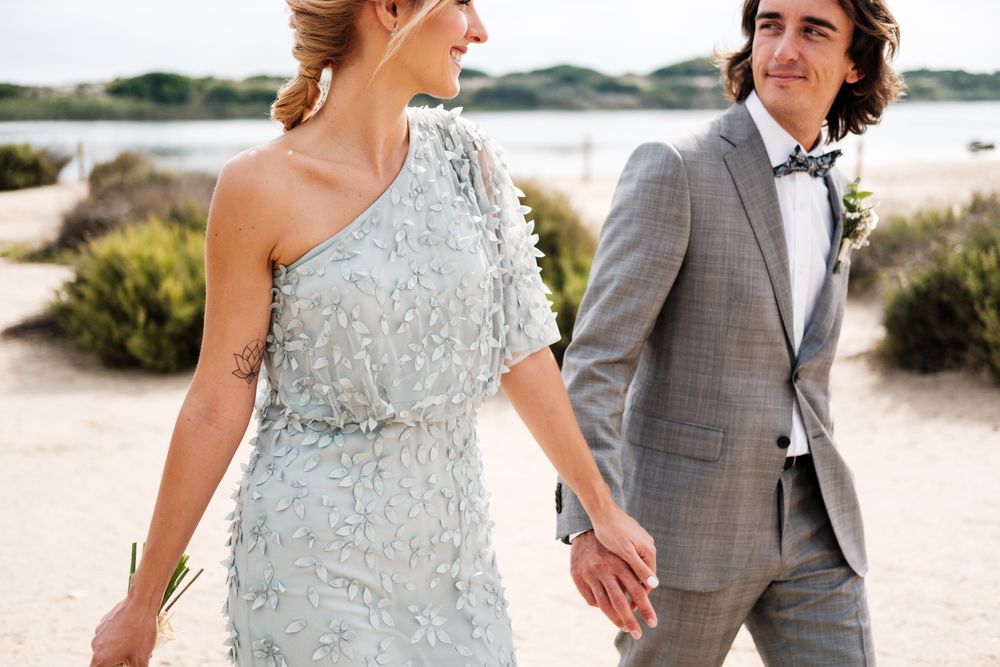Happy young married couple spending time together at seaside