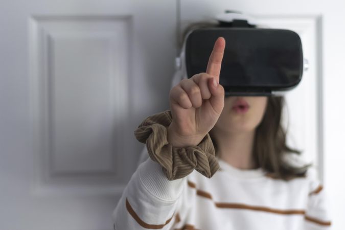 Girl wearing VR headset leaning on door